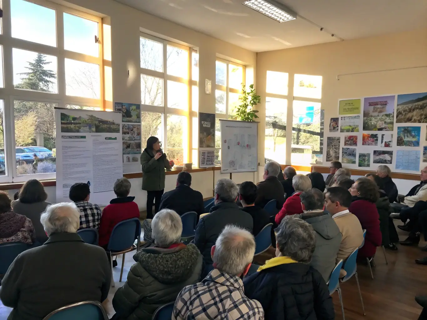 A photograph showing young members of COMITE INTERDEPARTEMENTAL FSCF AUBE - HAUTE-MARNE actively participating in a local town hall meeting, demonstrating their engagement in active citizenship and community governance.